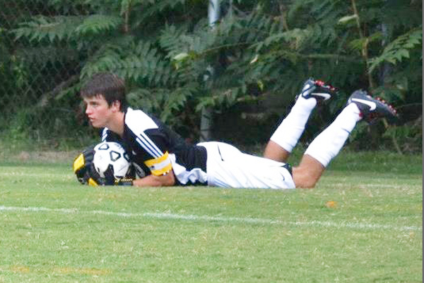 Senior Brady Buchanan dives to make a stop in front of the Demons goal. PHOTO PROVIDED BY MARGARET MORRISON