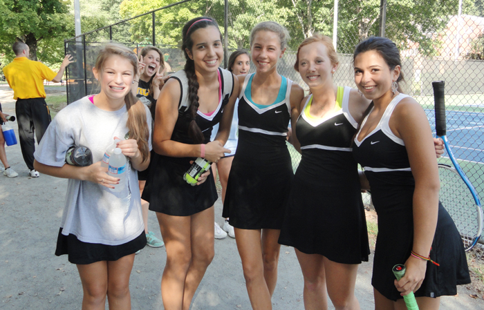The Demons enjoy a light-hearted moment before hitting the courts.From left are Charlotte Ririe, Cory Spencer, Jana Klages-Miller, Maggie Irvin and Juliana Costa. PHOTO BY MADISON WATTS
