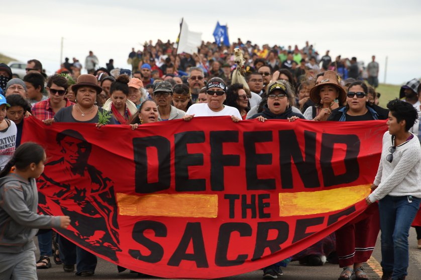 Native Americans march to a burial ground sacred site that was disturbed by bulldozers building the Dakota Access Pipeline (DAPL), near the encampment where hundreds of people have gathered to join the Standing Rock Sioux Tribes protest of the oil pipeline that is slated to cross the Missouri River nearby, September 4, 2016 near Cannon Ball, North Dakota.
Protestors were attacked by dogs and sprayed with an eye and respiratory irritant yesterday when they arrived at the site to protest after learning of the bulldozing work. / AFP PHOTO / Robyn BECKROBYN BECK/AFP/Getty Images