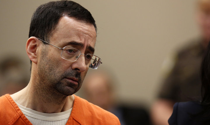 Former Michigan State University and USA Gymnastics doctor Larry Nassar appears at Ingham County Circuit Court on November 22, 2017 in Lansing, Michigan.  
Former USA Gymnastics team doctor Lawrence (Larry) Nassar, accused of molesting dozens of female athletes over several decades, on Wednesday pleaded guilty to multiple counts of criminal sexual conduct. Nassar -- who was involved with USA Gymnastics for nearly three decades and worked with the countrys gymnasts at four separate Olympic Games -- could face at least 25 years in prison on the charges brought in Michigan.
 / AFP PHOTO / JEFF KOWALSKY        (Photo credit should read JEFF KOWALSKY/AFP/Getty Images)