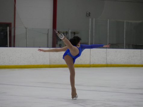 Sansour glides on the ice, practicing their moves.