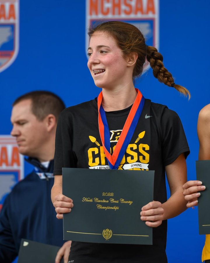 Photo provided by Robert Hill - Welsh standing tall as she receives her 3rd place award at North Carolinas 4A Cross Country State Championship.