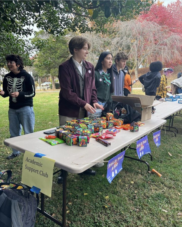 Photo Provided by RJ Reynolds PTSA - Members of the Academic Support Club sell “Boo Boxes” with treats for Halloween.