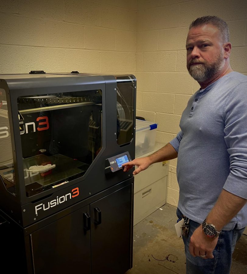 Andrew Biles uses the 3D printer in his classroom. 