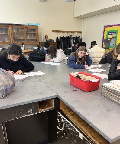 Students take a teacher-made final exam in their semester-long Honors Chemistry class. 