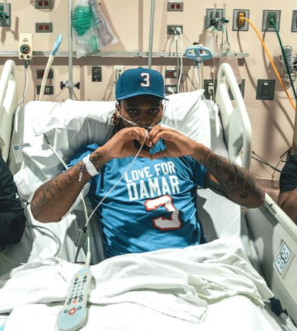 Damar Hamlin Holds up a heart for his followers post accident in Buffalo General Medical Center.