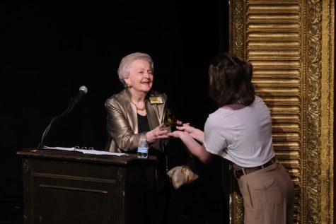 Senior Kyle Brady presents Phyllis Dunning with an award after being inducted into the RJR Arts Hall of Fame. 
